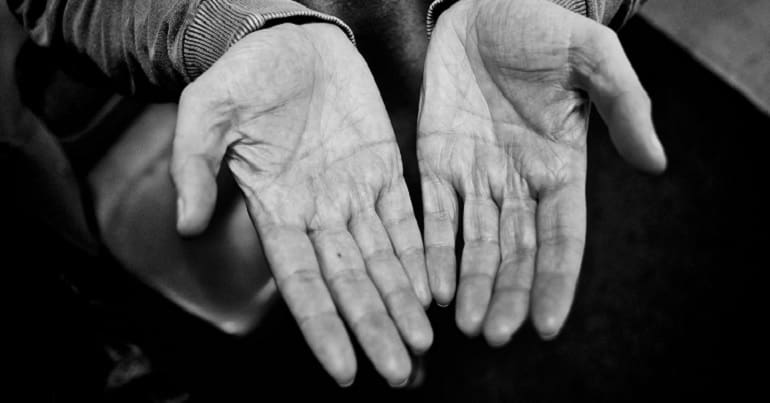 A pair of hands representing poorer people