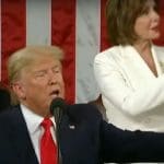 Donald Trump with Nancy Pelosi clapping behind him