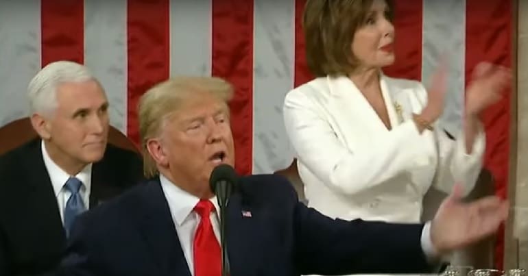 Donald Trump with Nancy Pelosi clapping behind him