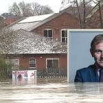 A picture of George Esutice submerged in floodwater