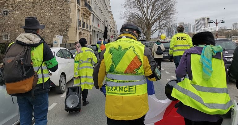 Yellow Vest march along the river Seine.