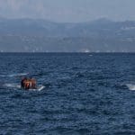 3 boats with refugees are arriving to the beaches of Skala Sykamia, in the background you can see another 2 boats, Lesvos island, Greece (photo taken in 2015)