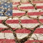 US flag on ground with cracks in it