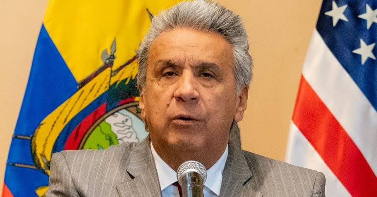Ecuadorian president Lenín Moreno in front of Ecuadorian and US flags
