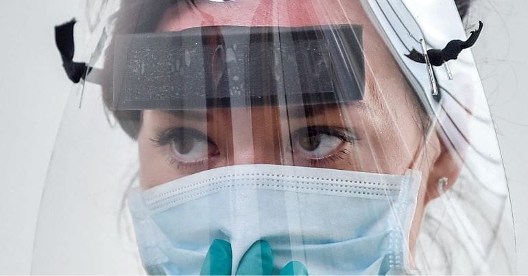 Person wearing a mask and visor