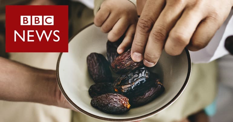 Family sharing dates from a bowl