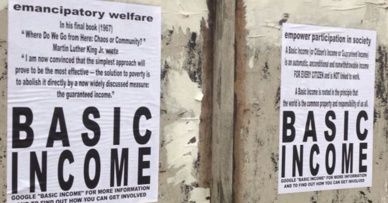 Basic Income posters on a walll