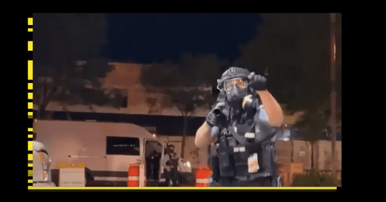 Riot officer pointing at the camera