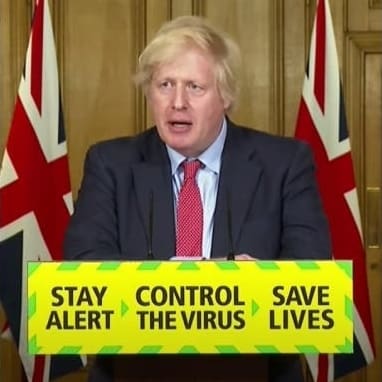 Boris Johnson and placard with quote "a riot is the language of the unheard"