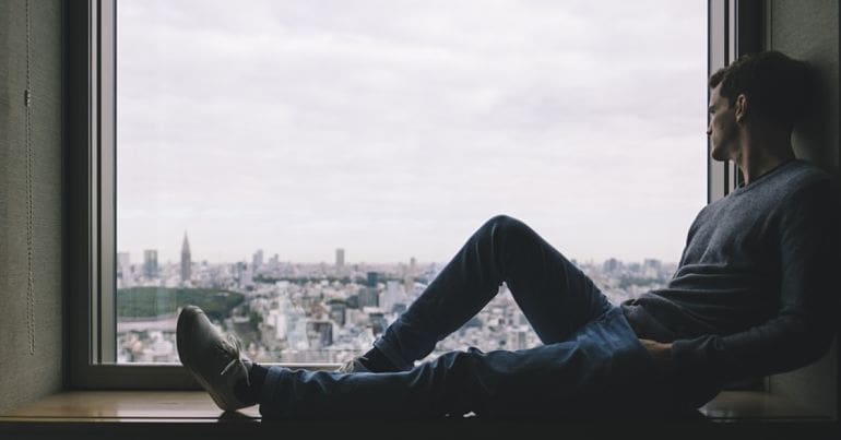 Young man sitting at a window