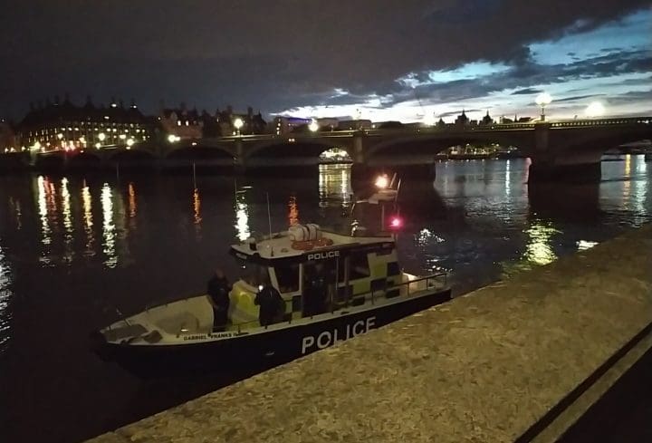 Police on a boat demanded that a/political and Media Gang cease projecting onto parliament
