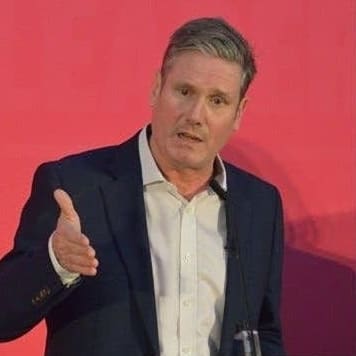 Keir Starmer and an armed police officer