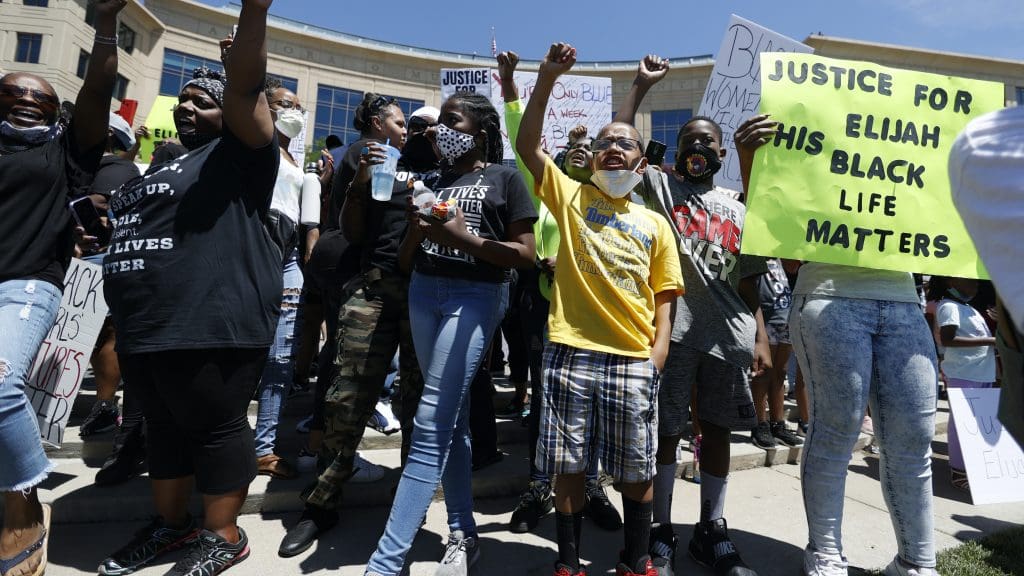 Protesters holding Black Lives Matter signs