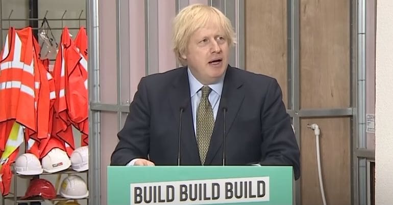 Boris Johnson making his coronavirus recovery speech behind a lecturn that reads 'build build build'