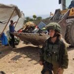 Israeli forces demolish a vegetable stall in the occupied Jordan Valley