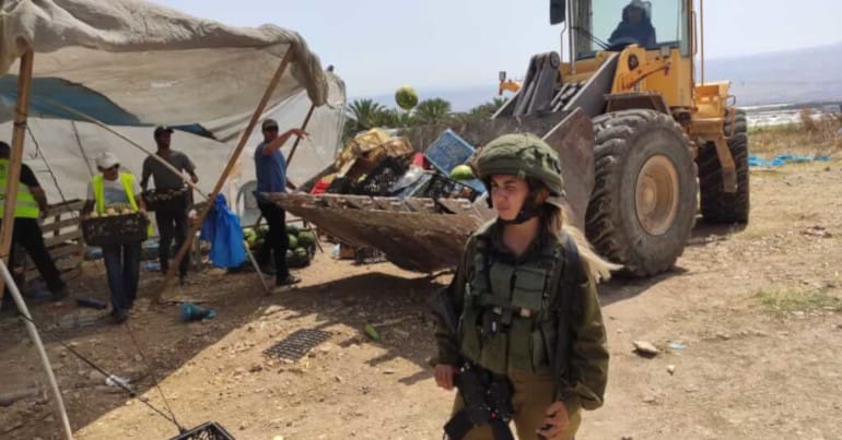 Israeli forces demolish a vegetable stall in the occupied Jordan Valley
