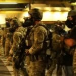 Armed federal agents block a street in Portland, Oregon