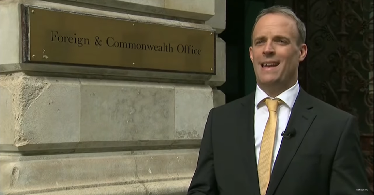 Dominic Raab standing in front of Foreign and Commonwealth Office