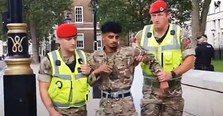 Ahmed Al-Babati being arrested by military police