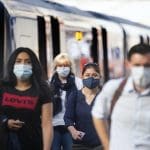 Rail commuters wearing face masks