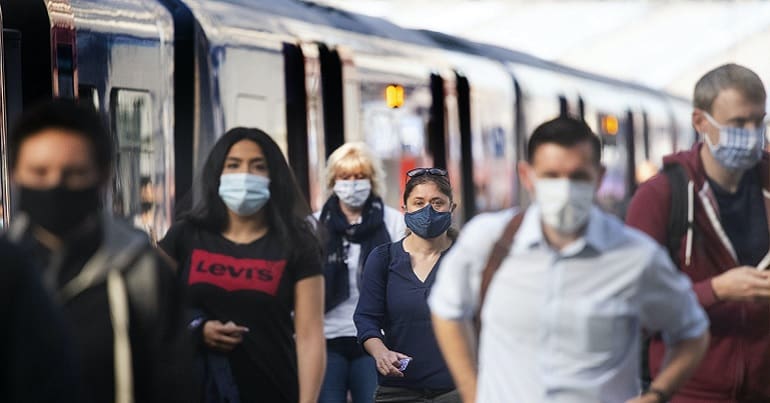 Rail commuters wearing face masks