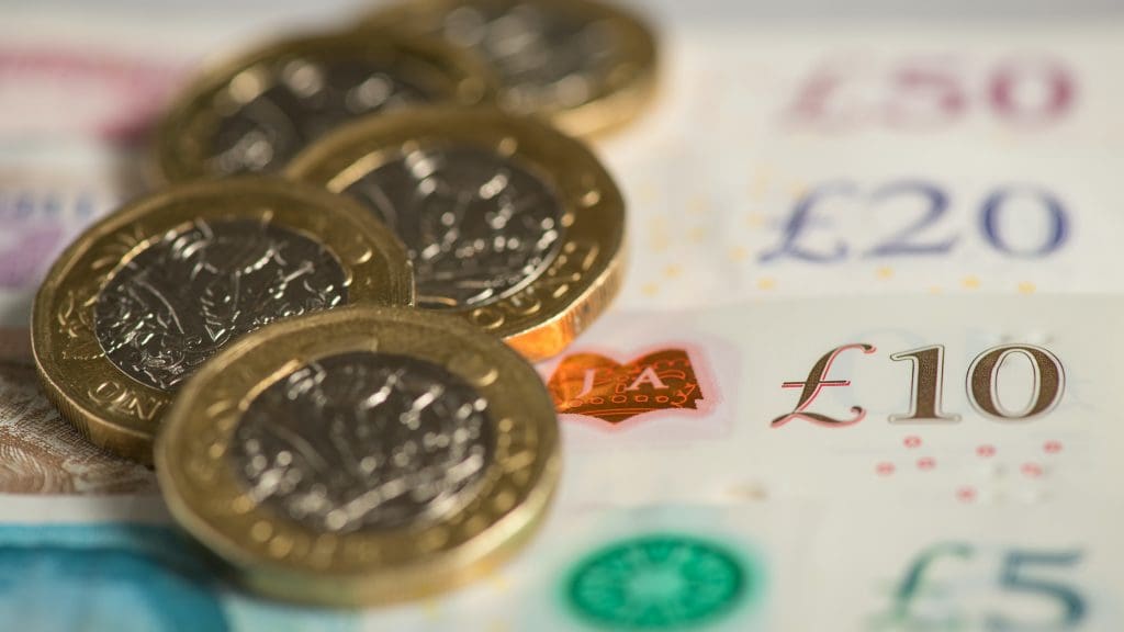 Pound coins on top of £20 notes