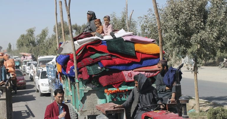 People in Afghanistan on a tractor