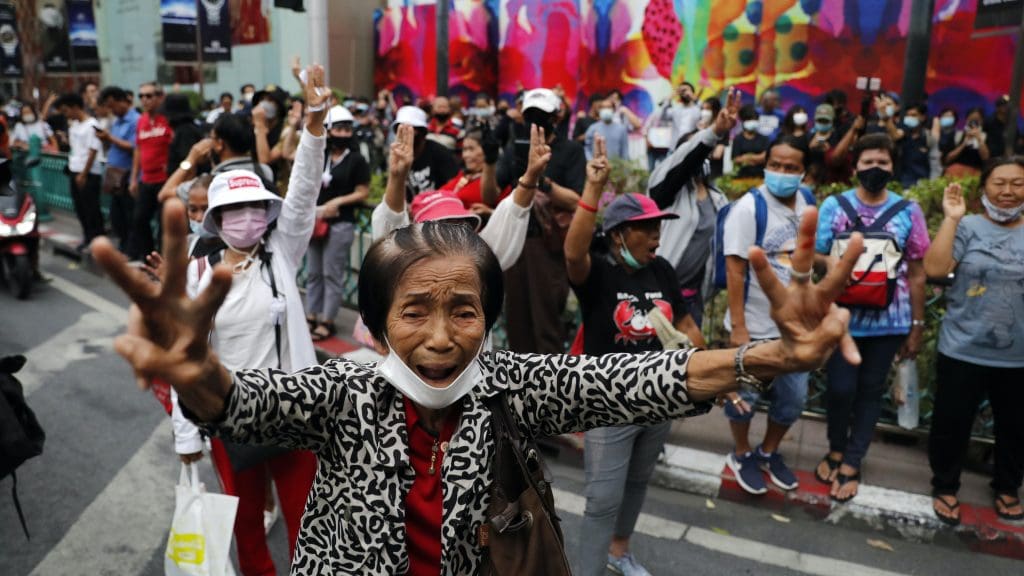 Protesters holding three fingers up
