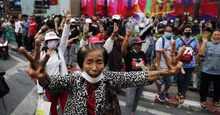 Protesters holding three fingers up