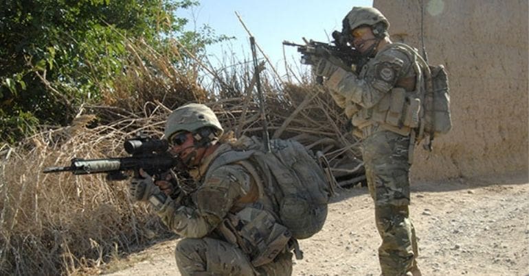 British soldiers aiming assault rifles