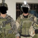 Soldiers with their faces blacked over
