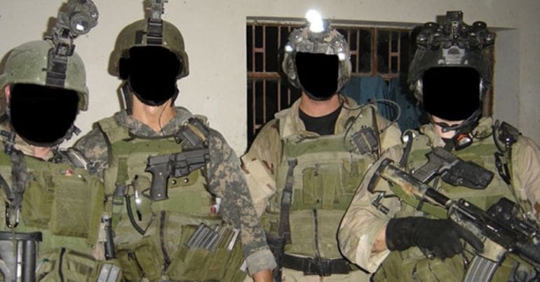 Soldiers with their faces blacked over