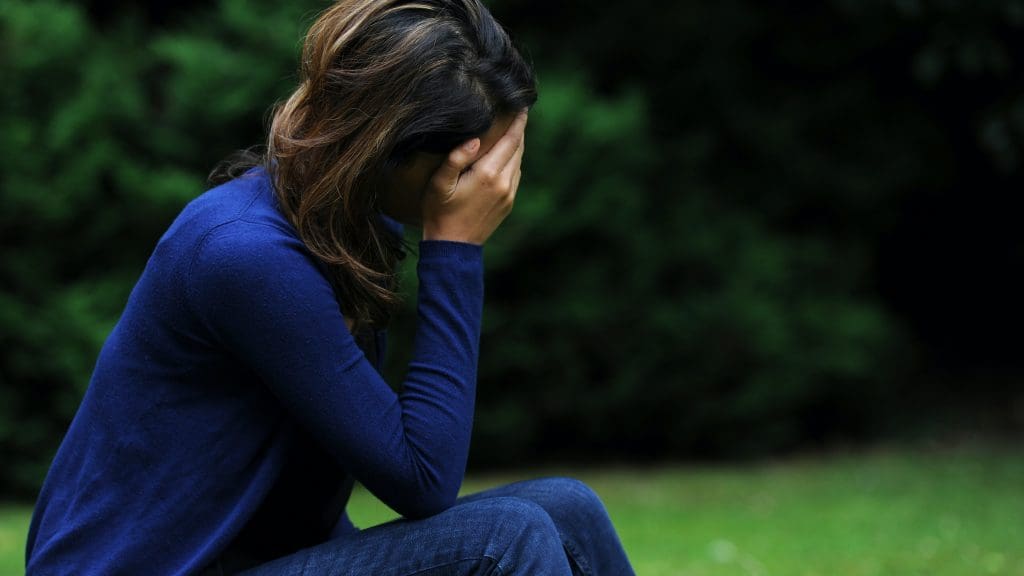 A woman with her head in her hands