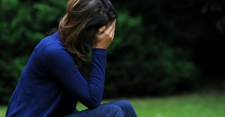 A woman with her head in her hands