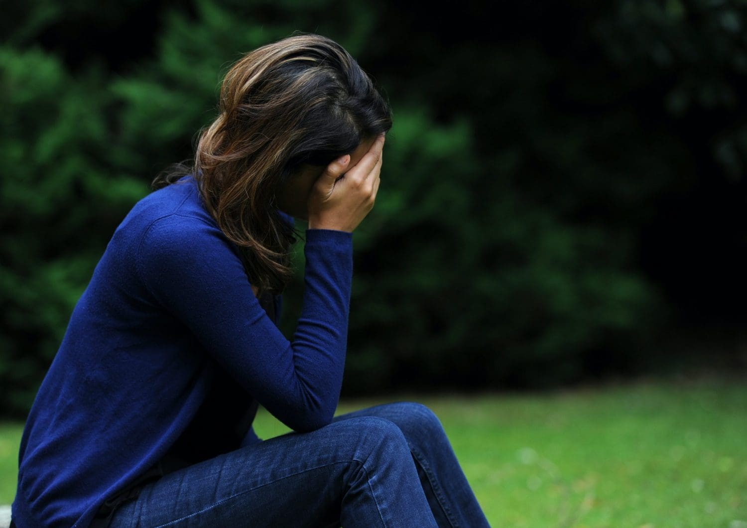 A woman with her head in her hands