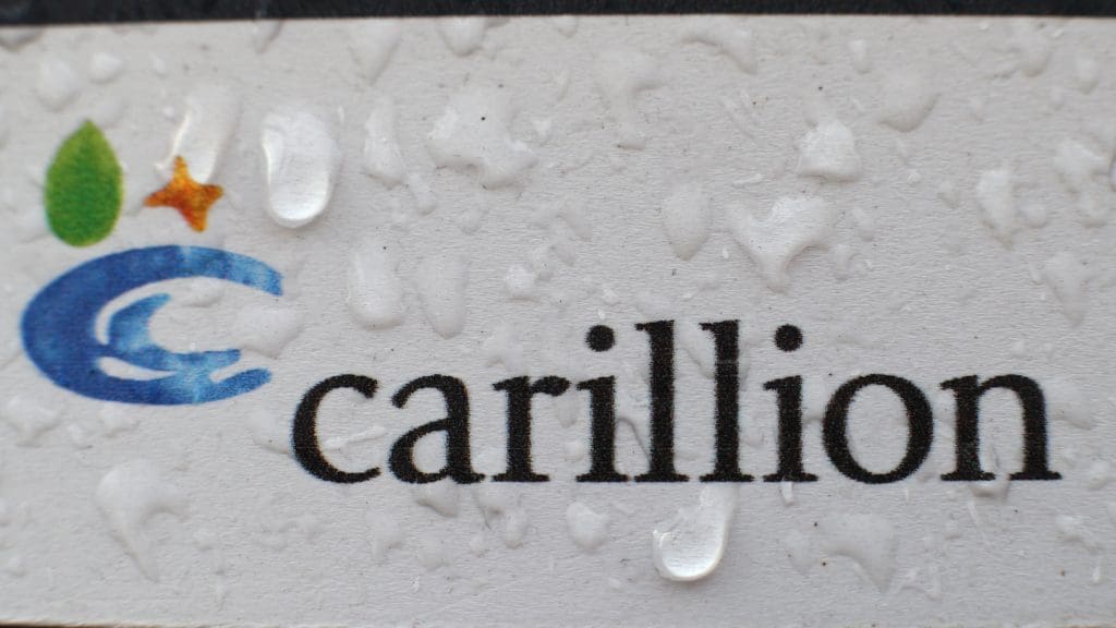 The Carillion logo with rain water on it