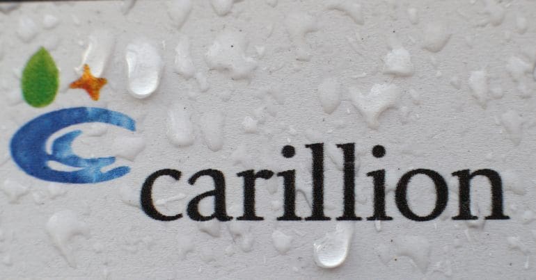 The Carillion logo with rain water on it