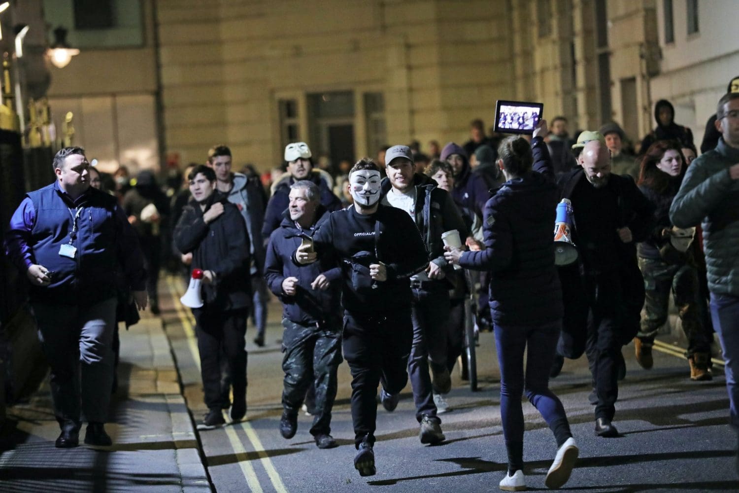 Protesters running from the police