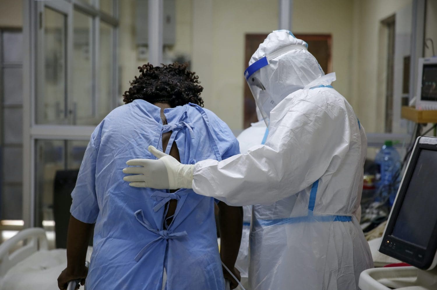 A patient with a doctor wearing a full suit of PPE