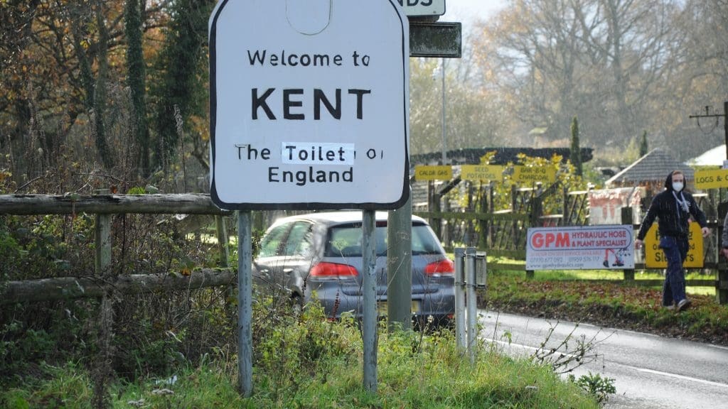 A road sign which reads 'Welcome to Kent: The toilet of England'