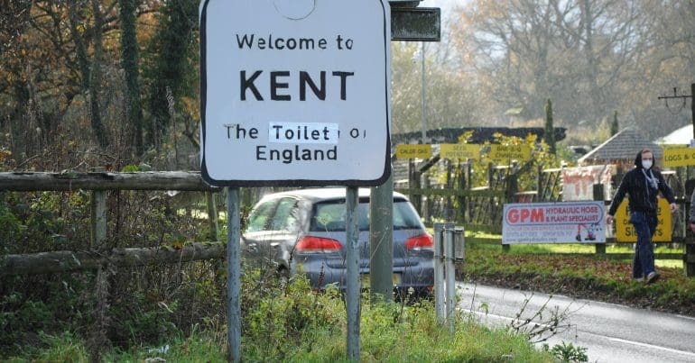 A road sign which reads 'Welcome to Kent: The toilet of England'