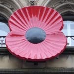 A large Rememberance poppy on the front of a building