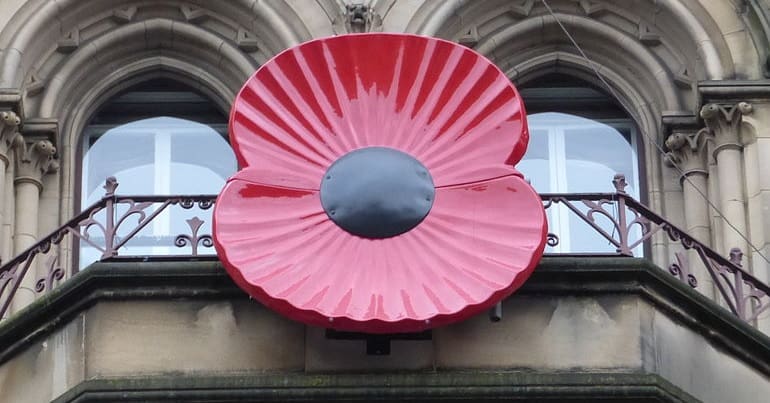 A large Rememberance poppy on the front of a building