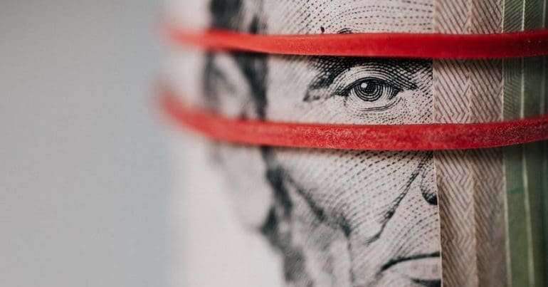 A rolled up dollar bill