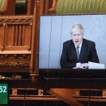 Boris Johnson being broadcast onto a screen in parliament