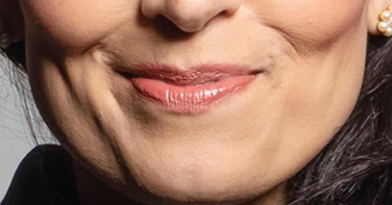 A close up of Priti Patel's smirk