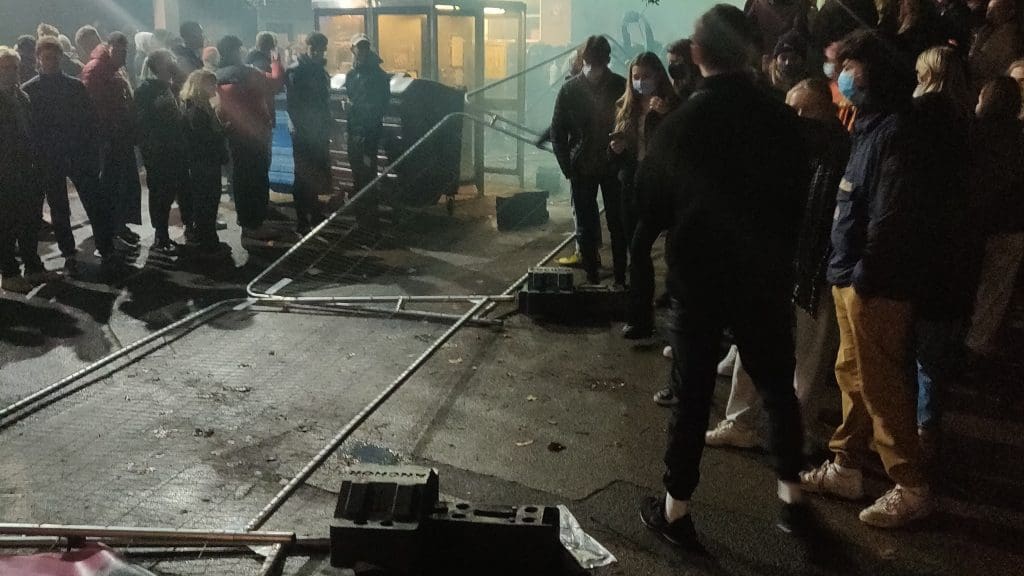 Protesters in the aftermath of tearing down the fence