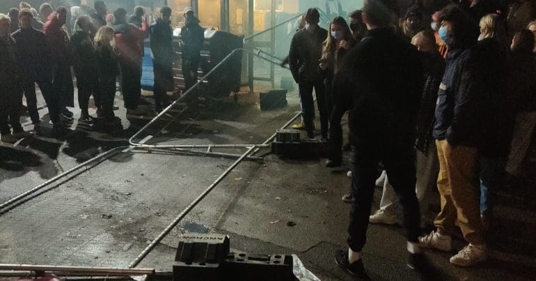 Protesters in the aftermath of tearing down the fence
