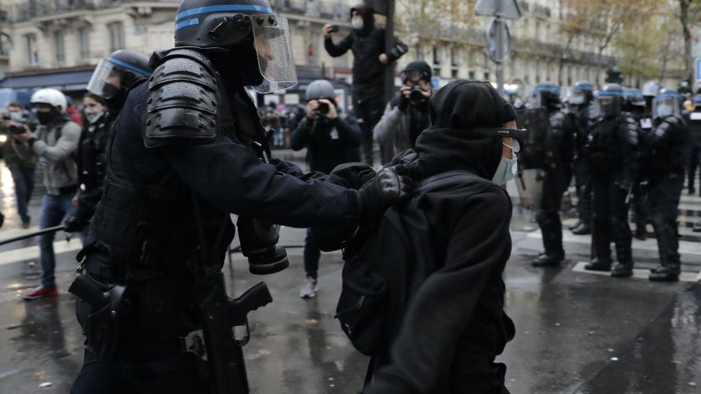 Riot police in Paris manhandling a protestor