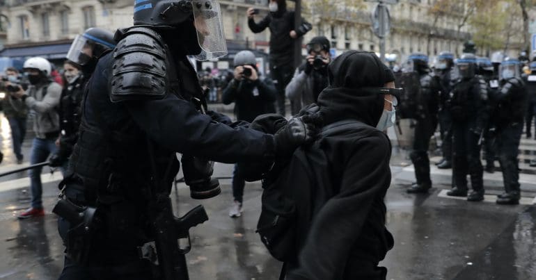 Riot police in Paris manhandling a protestor